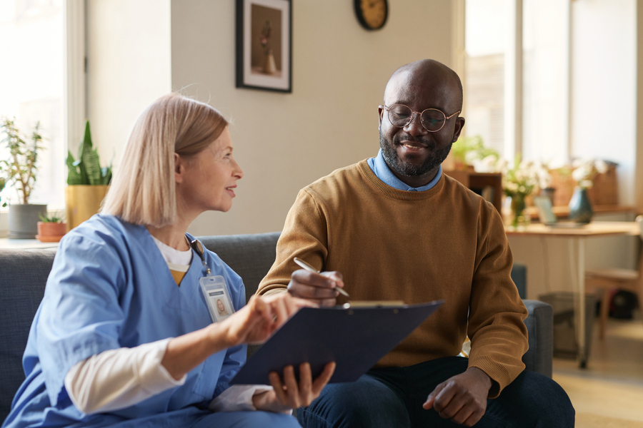 Black Man Signing Agreement on Clipboard
